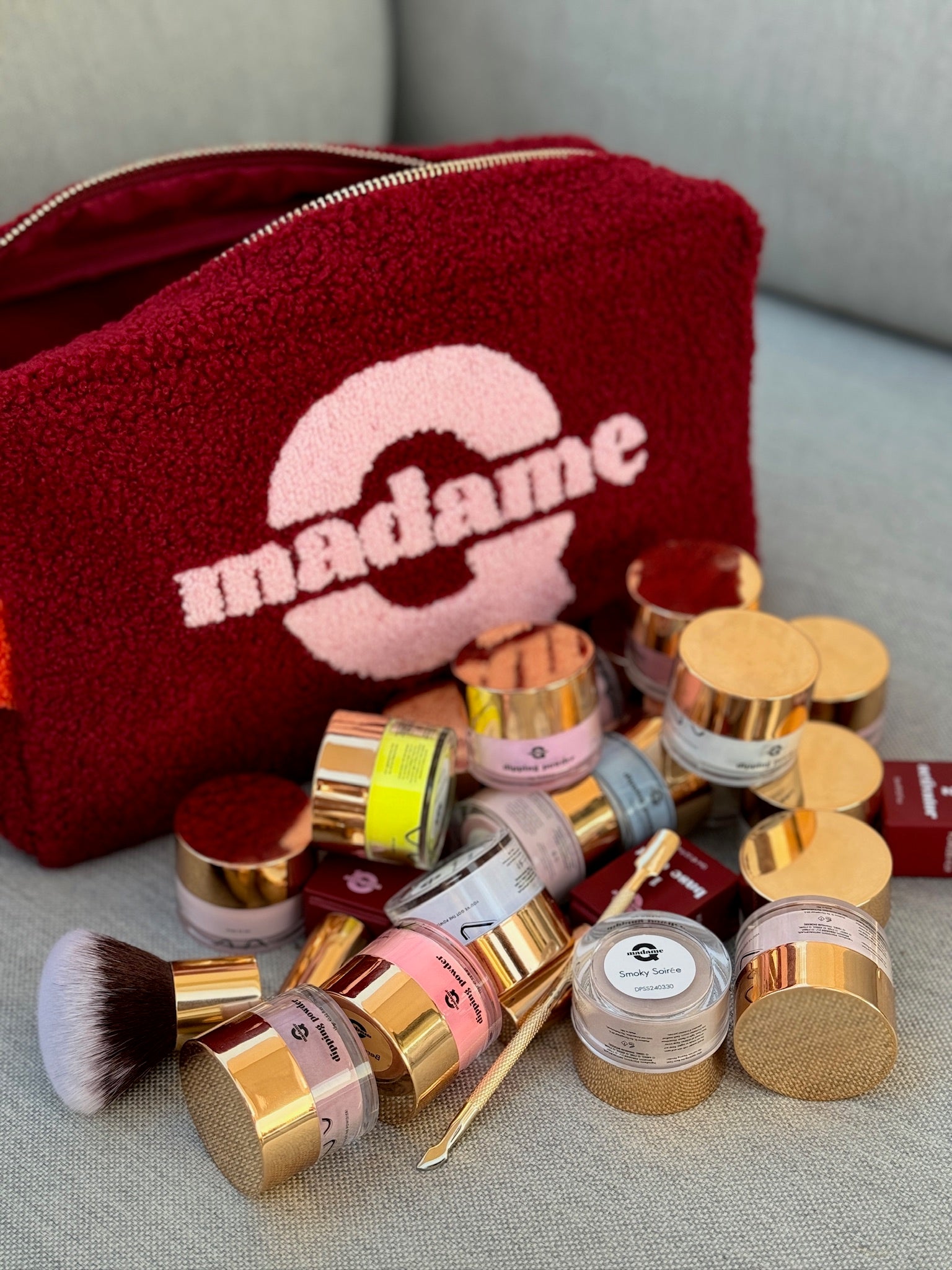 stack of dipping powder jars, accesories and Madame Q Travel Bag